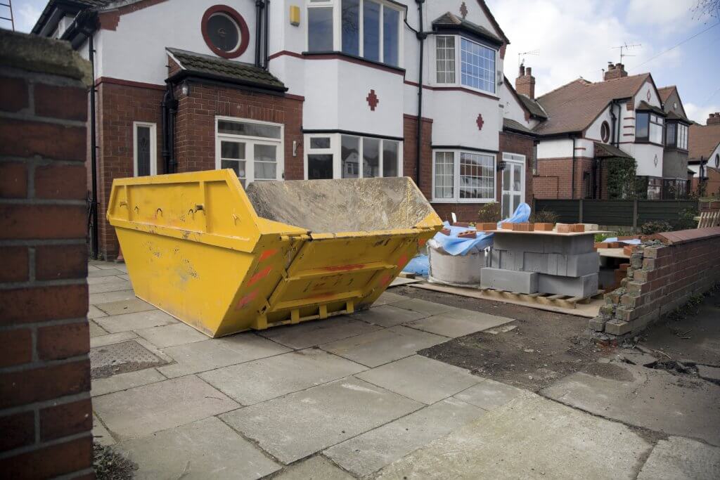 Empty skip on driveway ready for loading with waste